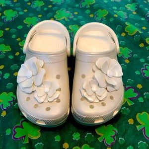 White pearlescent Crocs with flowers